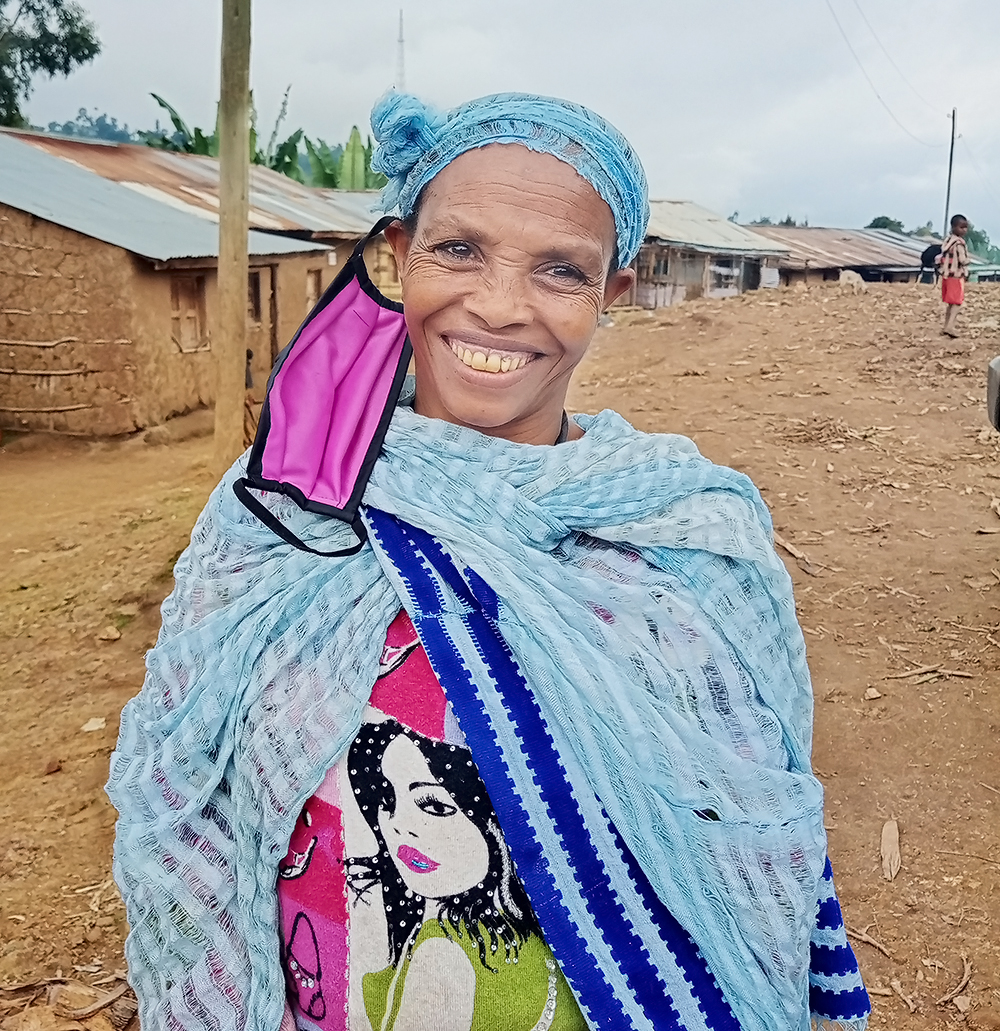 Ambassador Azalech Tsigie smiles with her PPE mask askew